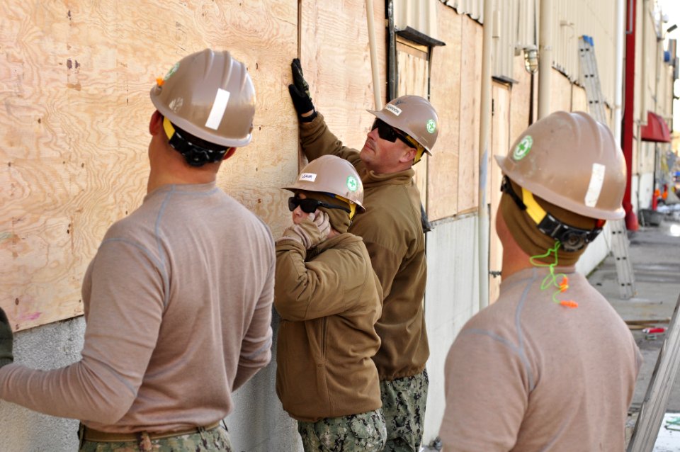 Seabees install plywood on damaged buildings. (8200229686)