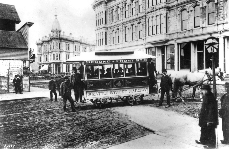 Seattle Street Railway, the first streetcar in Seattle, at Occidental Ave and Yesler Way with Mayor John Leary and city (CURTIS 2035)