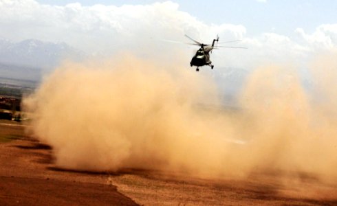 An Afghan National Army Air Corps helicopter causes a dust storm during lift off. (4489794478)