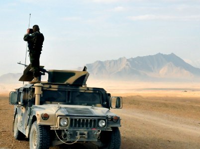 An Afghan National Army soldier stands atop his HMWV in the early morning providing security for fellow soldiers (4335158858) photo