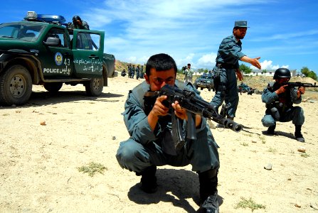 An Afghan National Civil Order Police (ANCOP), 2nd Lt., center, instructs members of the elite force during convoy operations training at a Kabul facility (100419-N-9594C-001) photo