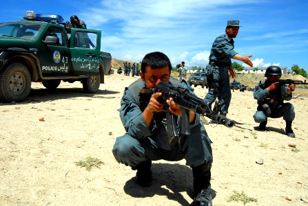 An Afghan National Civil Order Police (ANCOP), 2nd Lt., center, instructs members of the elite force during convoy operations training at a Kabul facility (100419-N-9594C-001)