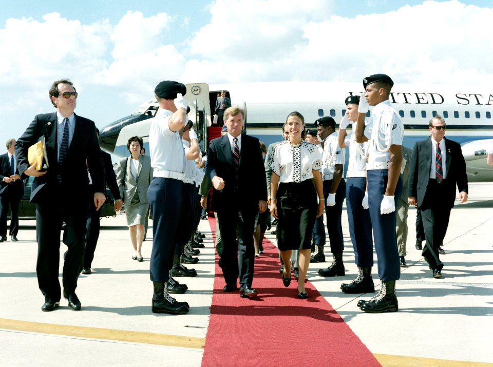 An Air Force honor guard salutes as Vice President J. Danforth Quayle and Marilyn Quayle arrive on base for a visit