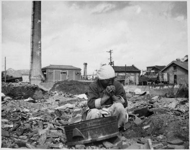 An aged Korean woman pauses in her search for salvageable materials among the ruins of Seoul, Korea. - NARA - 531387