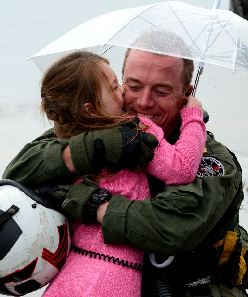 An aviator hugs his daughter after returning home. (8205192625)