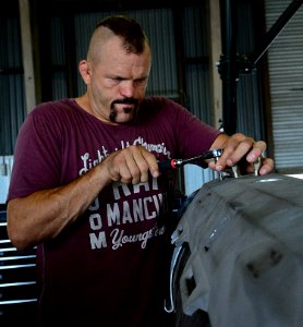 Chuck “The Iceman” Liddell, a retired American mixed martial artist, tightens a bolt