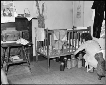 Daughter of Archie Isreal, miner. Two adults and five children live in this three room house which rents for $5.25... - NARA - 541123