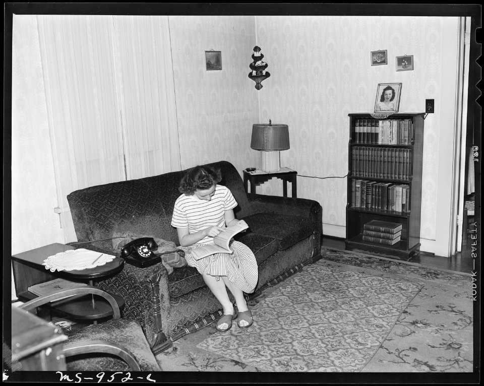 Daughter of Cecil Allgood, miner, looks up a number in the telephone directory. Her home is part of company housing... - NARA - 540624