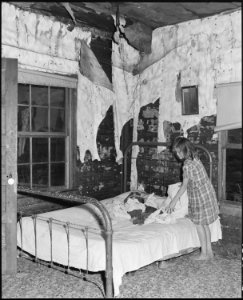 Daughter of Charlie Lingar in the bedroom of the three room house for which they pay $ 6.75 monthly. Kentucky... - NARA - 541194