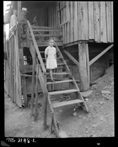 Daughter of Charlie Davis walking down the steps. Coleman Fuel Company, Red Bird Mine, Field, Bell County, Kentucky. - NARA - 541138