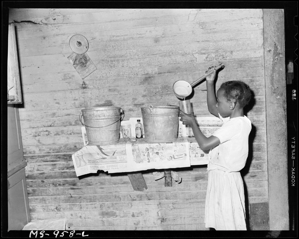 Daughter of Carlos Wilson, miner, pours herself a drink of water. Consolidated Coal Company, Bankhead Mine, Bankhead... - NARA - 540629