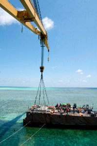 A crane vessel prepares to lift a hull section of the former USS Guardian. (8595822088)