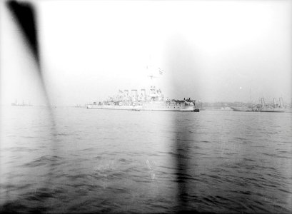 A distant view of the light cruiser HMS 'Aurora' (1913) at Harwich. RMG N22505