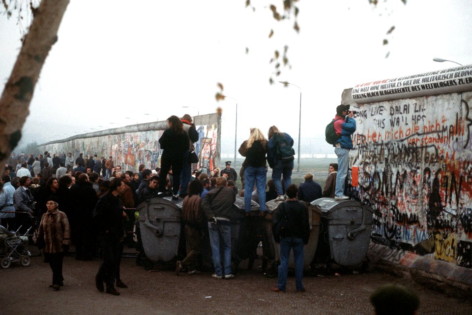 A crowd of West German citizens gathers at the newly created opening in the Berlin Wall at Potsdamer Platz