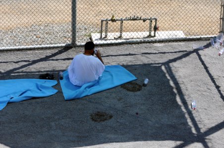 A detainee relaxes in the outdoor recreation area of Camp Six at Joint Task Force Guantanamo DVIDS380255