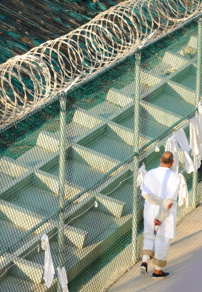A detainee walks within the outdoor recreation area of Camp Six at Joint Task Force Guantanamo DVIDS373571