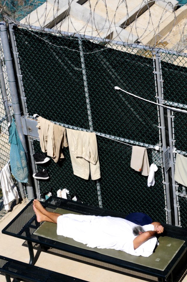 A detainee rests in the outdoor recreation area of Camp Six at Joint Task Force Guantanamo DVIDS380253