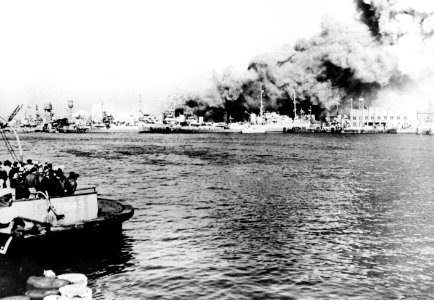 A fire destroys pier 3 at the St. Helena Annex of the Norfolk Naval Shipyard, Virginia (USA), on 16 January 1945 (NH 96333)