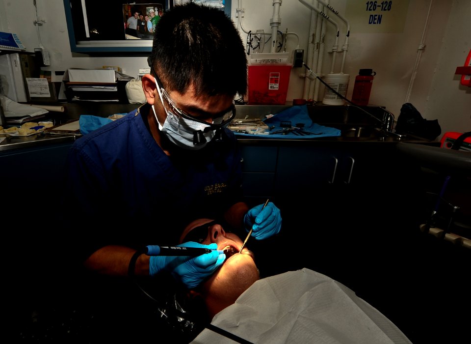 A dentist cleans teeth aboard USS Carl Vinson. (8515023907)