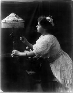 A General Electric advertising photograph - a woman with an electric lamp LCCN2011660037