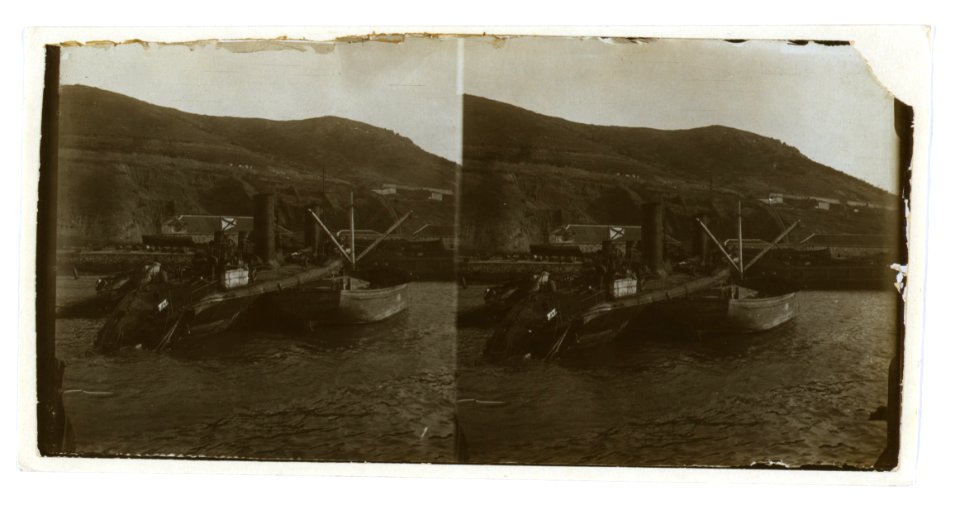 A destroyed Russian warship being salvaged by a smaller boat, Port Arthur LCCN2005678601