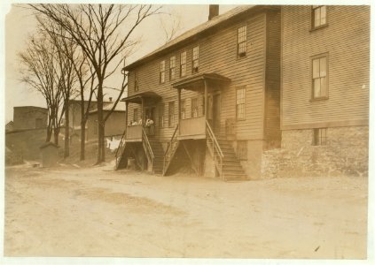 A four-family house crowded close to the Chace Cotton Mill, Burlington, Vt. Homes of mill hands. LOC nclc.01734