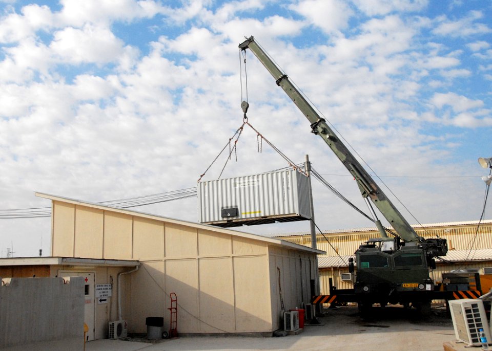 Armored crane moves shipping containers while expanding the ROLE 3 Hospital on Kandahar Airport -b