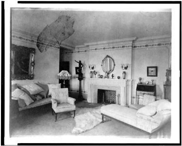Bedroom with fireplace, padded chaise longue, sofa, male nude statuette, and polar bear rug, in home of Edmund Cogswell Converse, Greenwich, Connecticut LCCN94502518