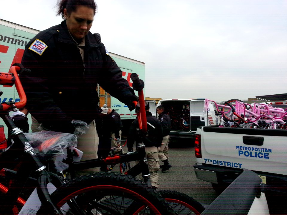 Cadet from the Metropolitan Police Department Academy loads a bicycle, one of many donated to the Toys for Tots program 131217-N-CG900-007