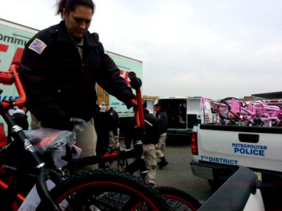 Cadet from the Metropolitan Police Department Academy loads a bicycle, one of many donated to the Toys for Tots program 131217-N-CG900-007 photo