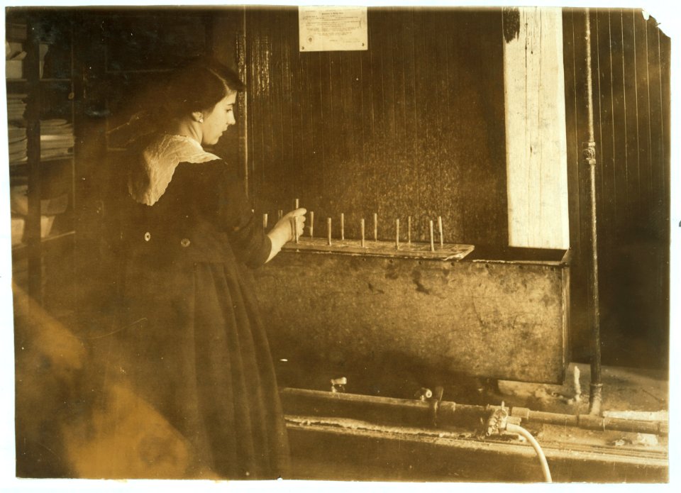 Celina Melchionno, 14 years old, waxing (dipping) flowers at the Boston Floral Supply Co., 347-357 Cambridge Street. Said to be the only flower factory in Massachusetts. LOC nclc.05159