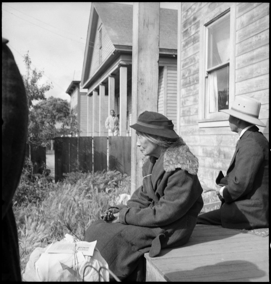 Centerville, California. Grandmother of farm family awaits evacuation bus. Evacuees of Japanese an . . . - NARA - 537571