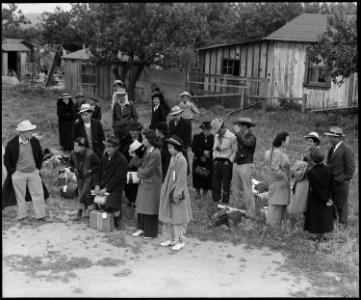 Centerville, California. Farm families of Japanese ancestry awaiting evacuation buses which will ta . . . - NARA - 537576 photo