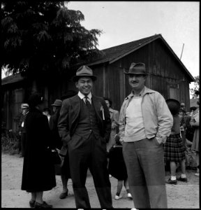 Centerville, California. A caucasian friend has come to say goodbye to his farmer friends of Japane . . . - NARA - 537555