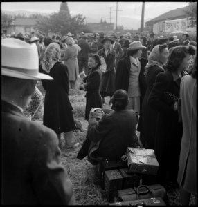 Centerville, California. Farm families of Japanese ancestry awaiting evacuation buses which will ta . . . - NARA - 537568