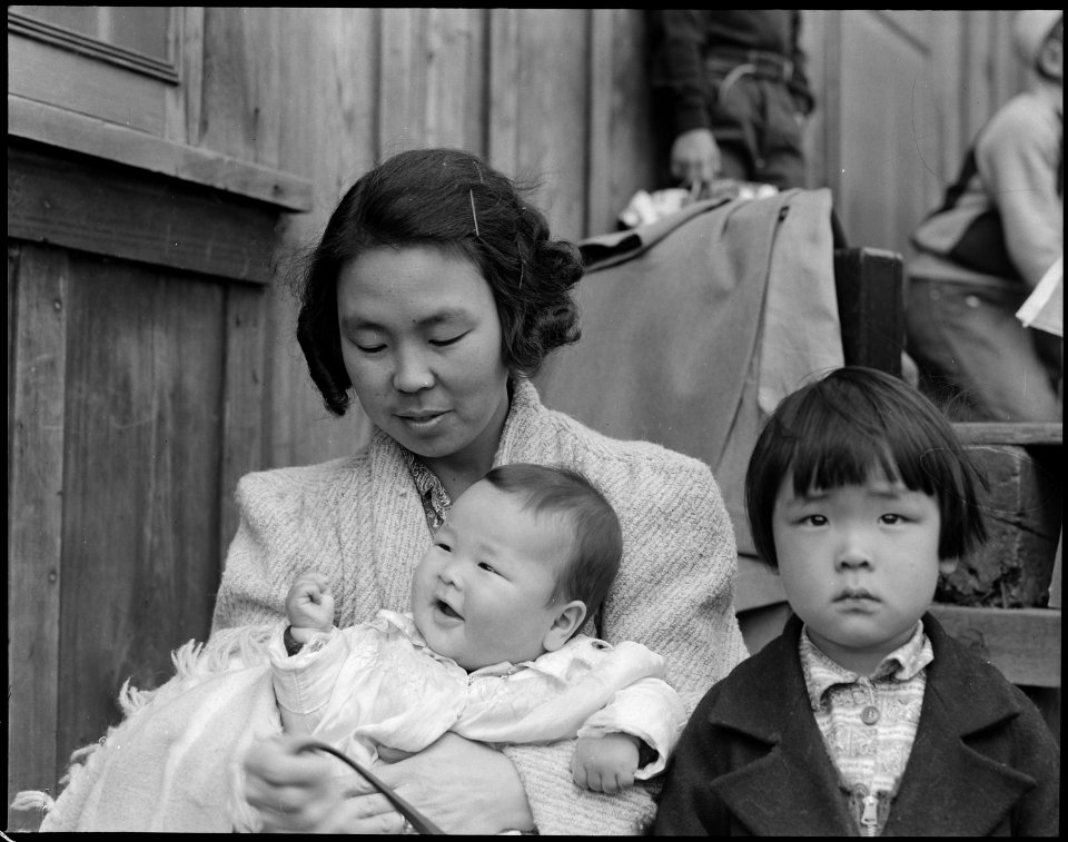 Centerville, California. Members of farm family await evacuation bus. In March they came from Sant . . . - NARA - 537573