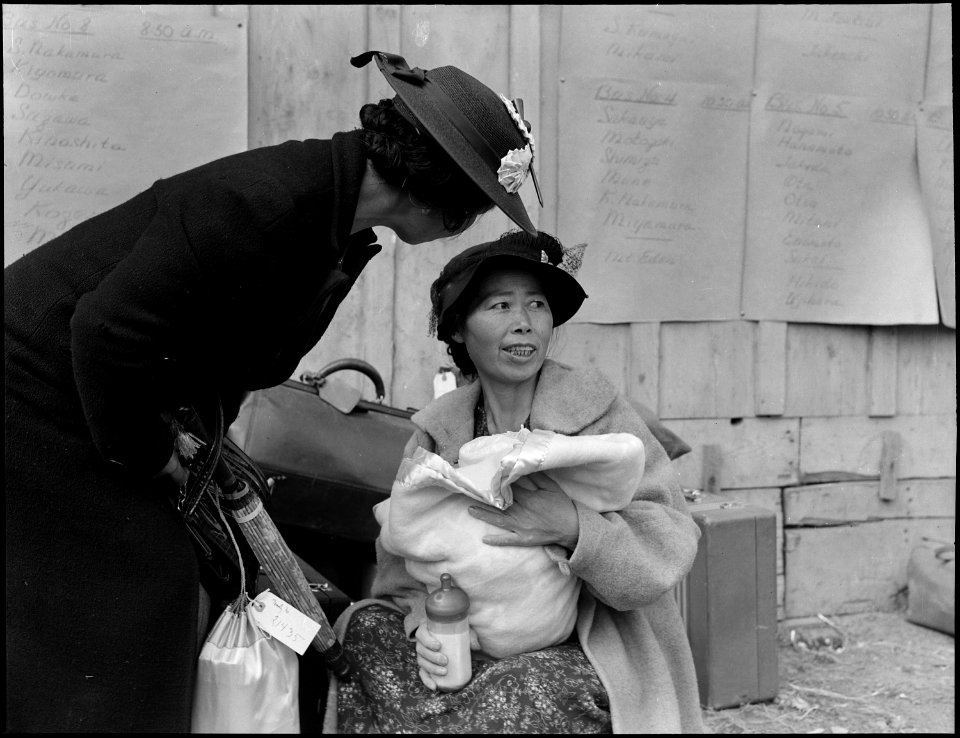Centerville, California. Mother and baby await evacuation bus. Posted on wall are schedules listin . . . - NARA - 537581