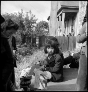 Centerville, Califronia. This farm youngster and members of her family await evacuation bus. Evacu . . . - NARA - 537572
