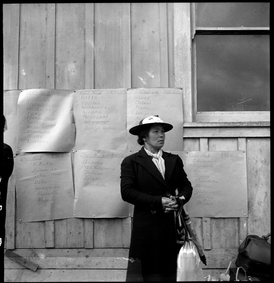 Centerville, California. Awaiting evacuation bus. Posters in Background list of families, buses to . . . - NARA - 537556