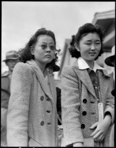 Centerville, California. School girls await evacuation bus. Evacuees of Japanese ancestry will be . . . - NARA - 537551 photo