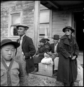 Centerville, California. Farm families of Japanese ancestry awaiting the evacuation buses which wil . . . - NARA - 537570 photo