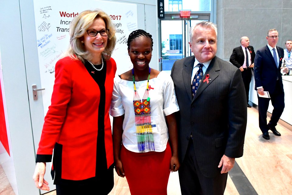 Deputy Secretary Sullivan and Ambassador Birx Pose for Photo With an Exhibit Visitor