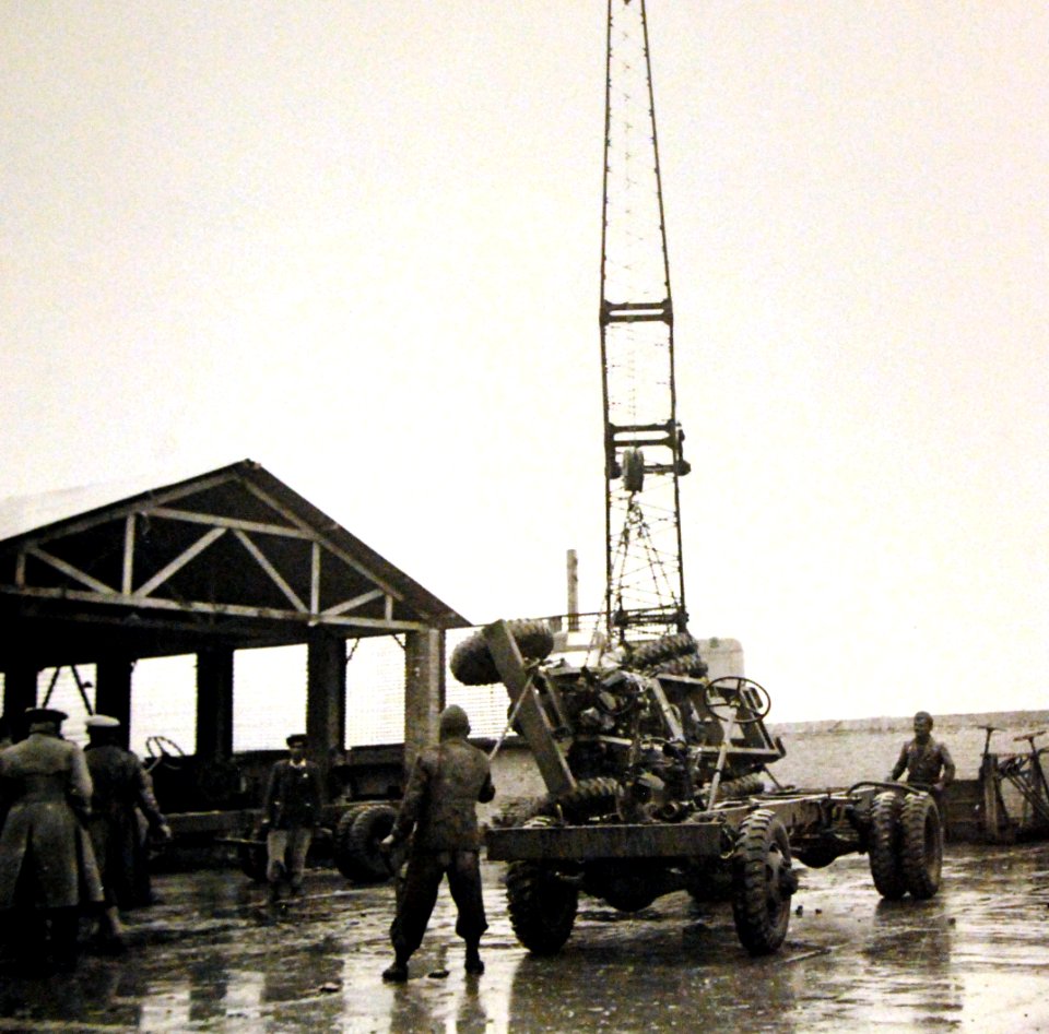 Derrick moving a truck chassis in rain, American truck assembly plant, Iran, 1943 (25039529841)