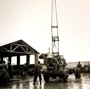 Derrick moving a truck chassis in rain, American truck assembly plant, Iran, 1943 (25039529841)