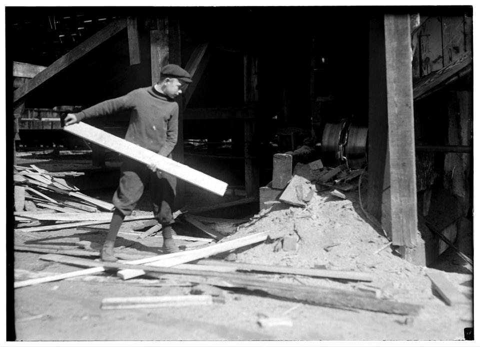 General Utility Boy in Miller & Vidor Saw-mill. 14 years old (he said). Part of the time he throws slabs into the chute that has chain carrying them to the mill. I saw him helping a man LOC nclc.05545