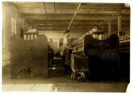 Erenne La Prise, a doffer, apparently 13 year(s) old, doffing at his machine in Spring Village Mill. Said he had been working a year and a half. LOC nclc.02304