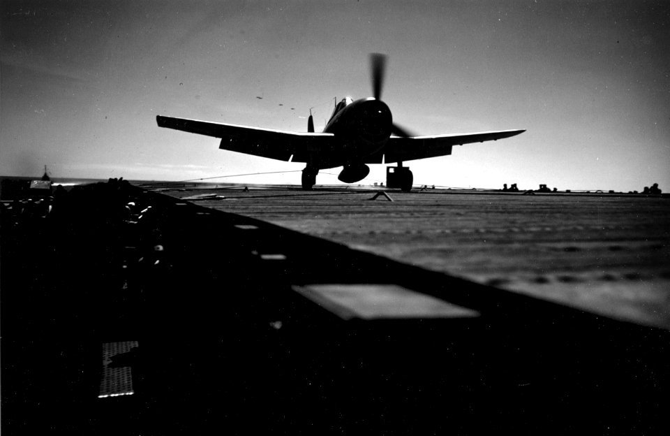Grumman F6F-3 Hellcat is stopped by an arresting wire aboard USS Cowpens (CVL-25), circa in late 1943 (80-G-K-1072)