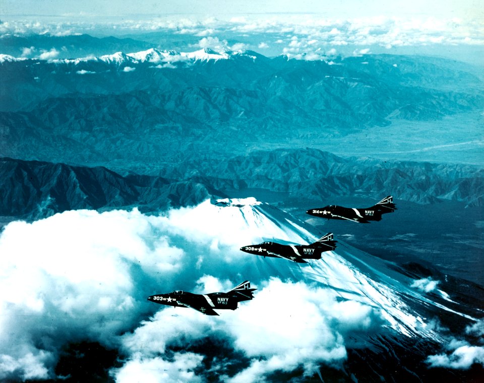 Grumman F9F-6 Cougars of VF-153 fly over Mount Fuji, Japan, 12 December 1954 (80-G-K-17821)