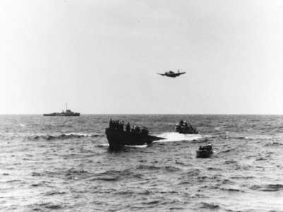 Grumman TBM Avenger of VC-8 flies over the captured German submarine U-505, 4 June 1944 (80-G-49168)