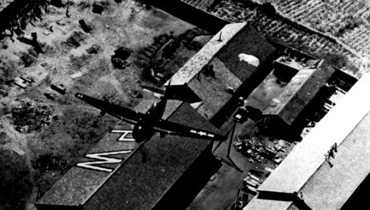 Grumman TBF Avenger of VT-9 drops supplies over a prisoner-of-war camp in Japan, circa in September 1945